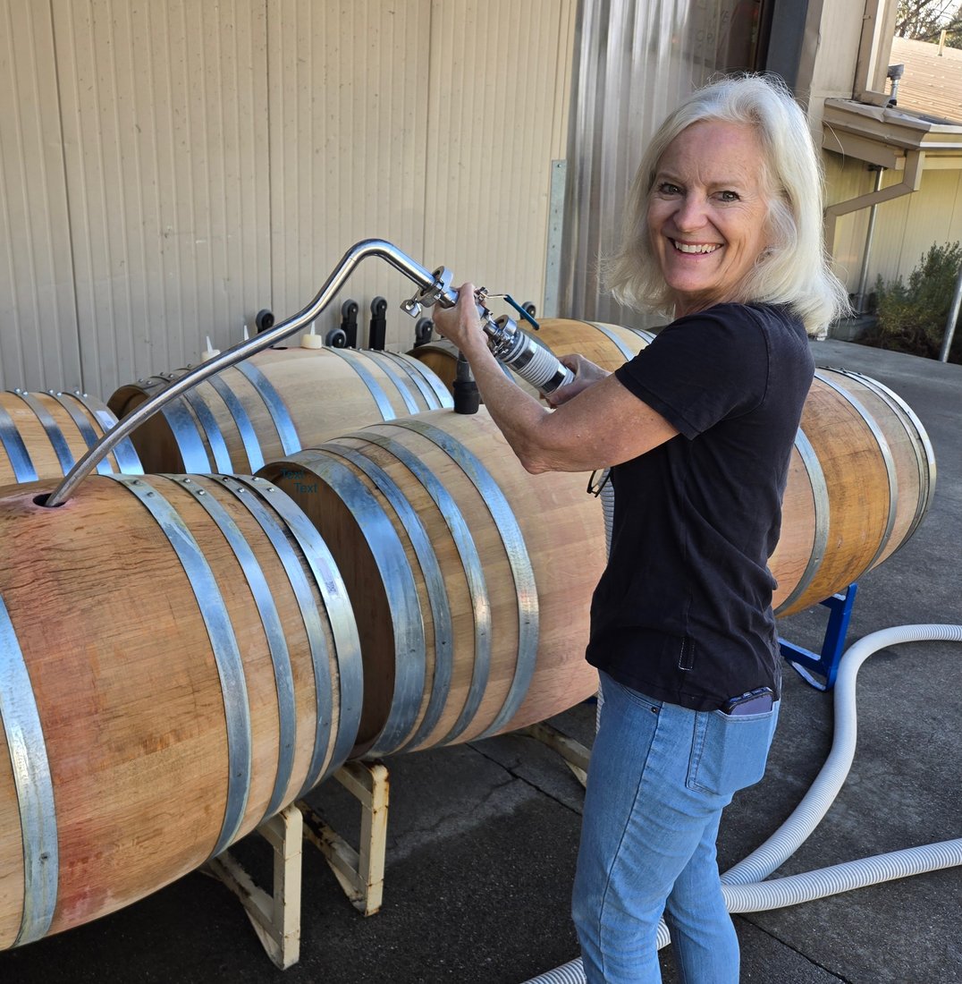 Laura topping barrels outside the winery